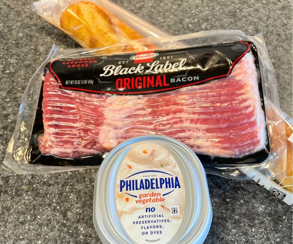 package of bacon, garden vegetable cream cheese, and french baguette