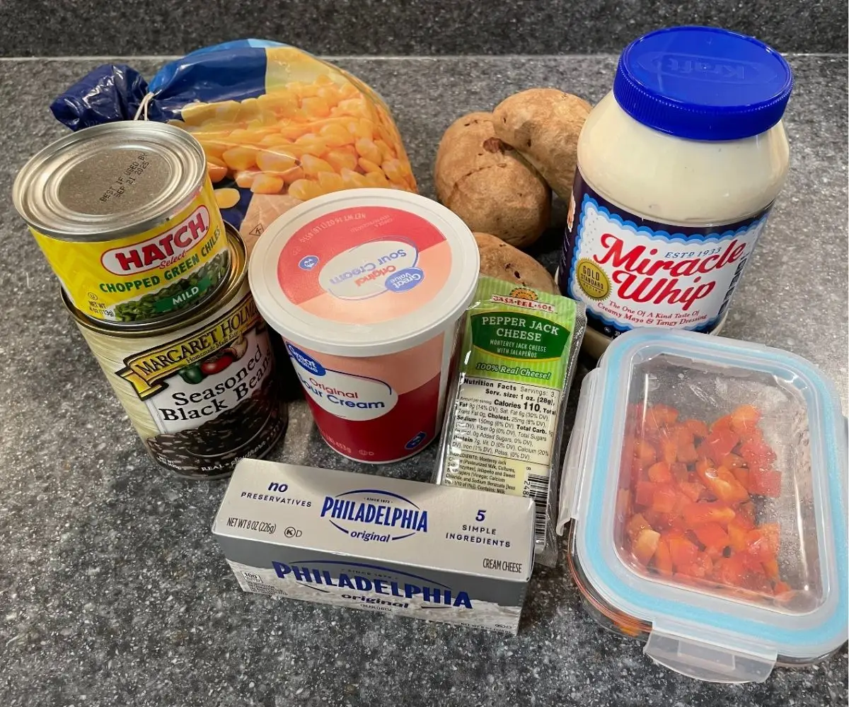 collection of ingredients to make stuffed bake potato recipe on kitchen counter