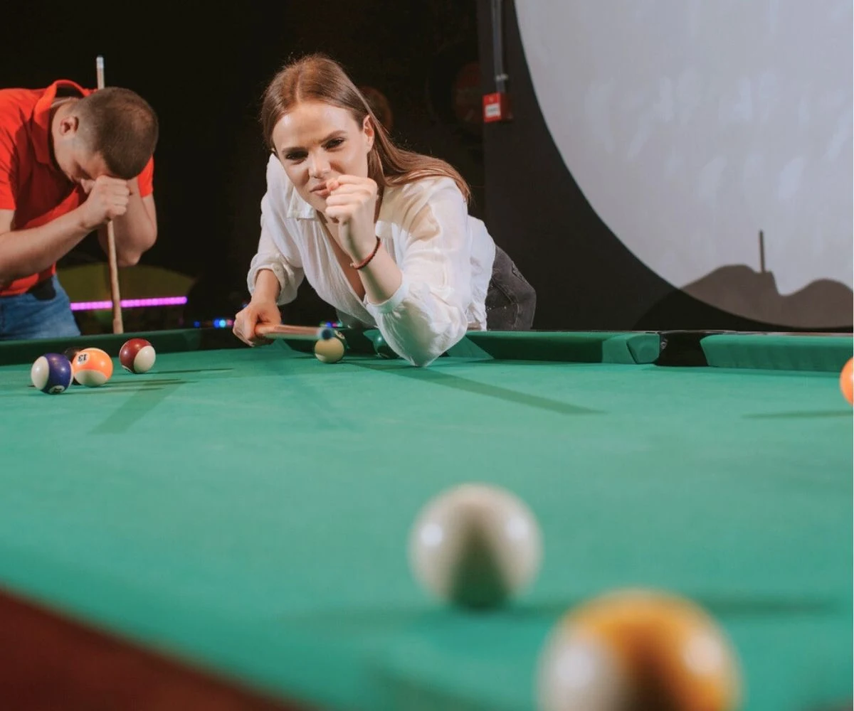 girl and boy couple competing at pool