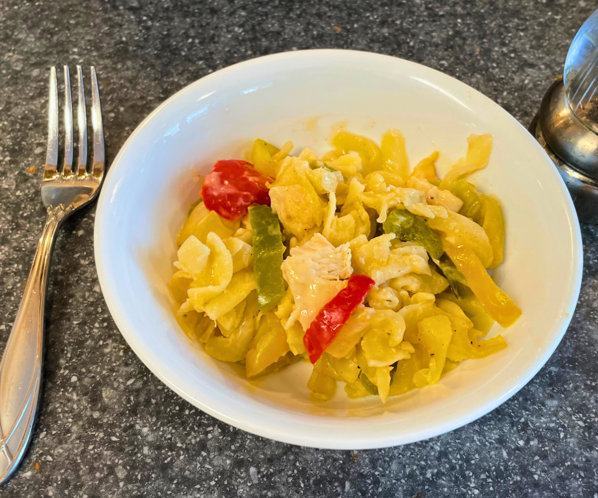 serving of cajun chicken alfredo bake in white bowl with fork