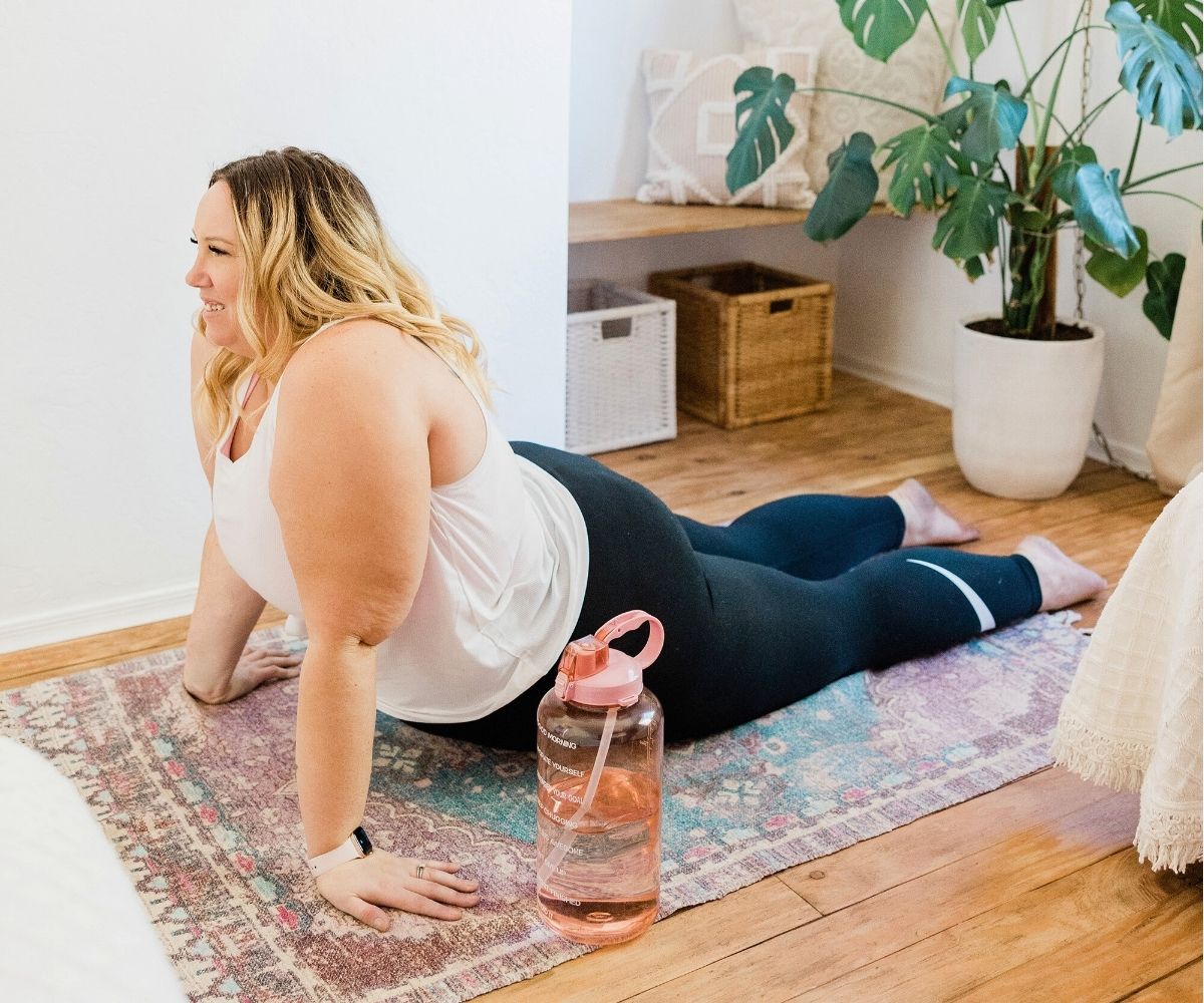 woman doing up-dog yoga posture at home