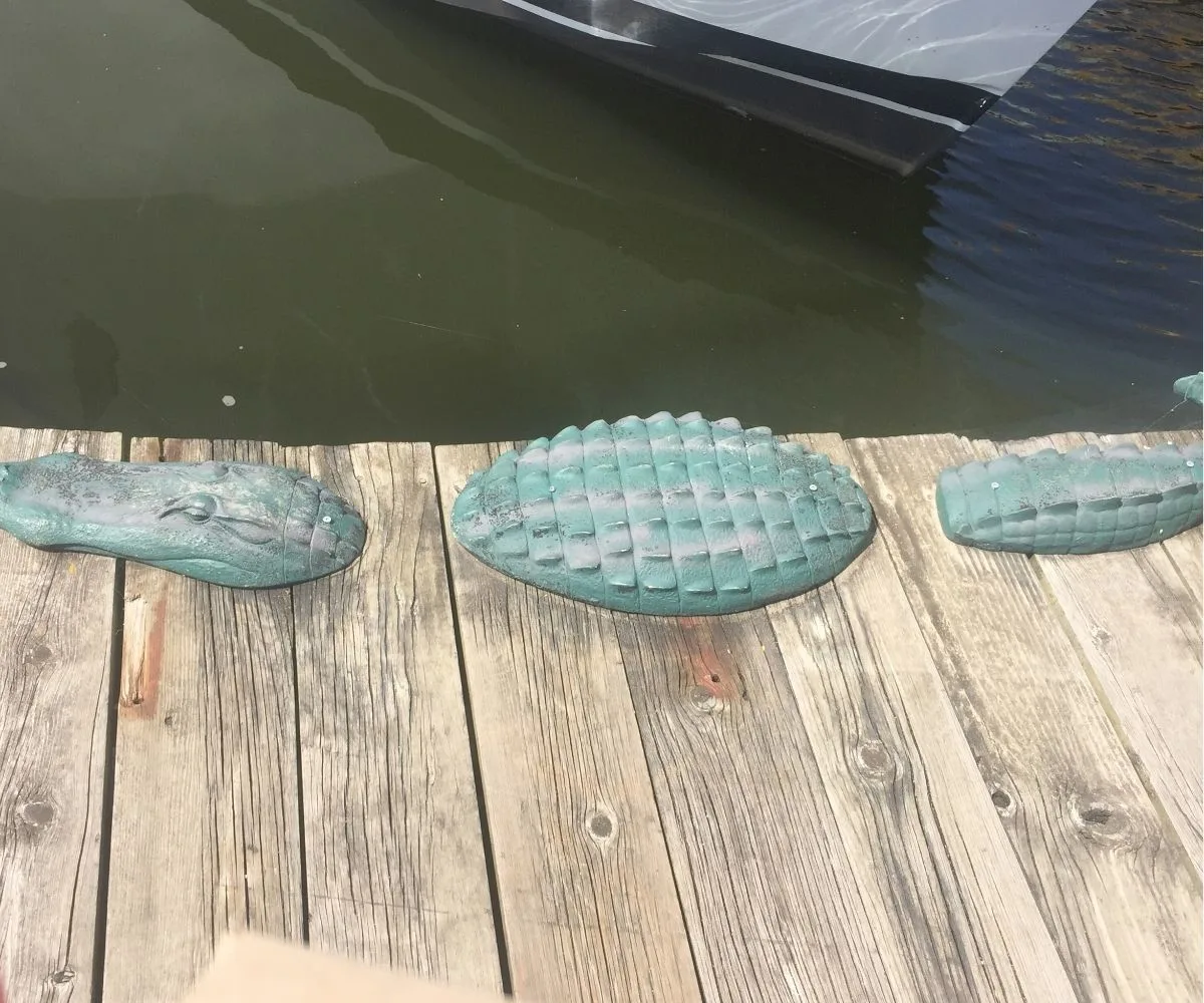 dock with copper alligator statue coming out of it
