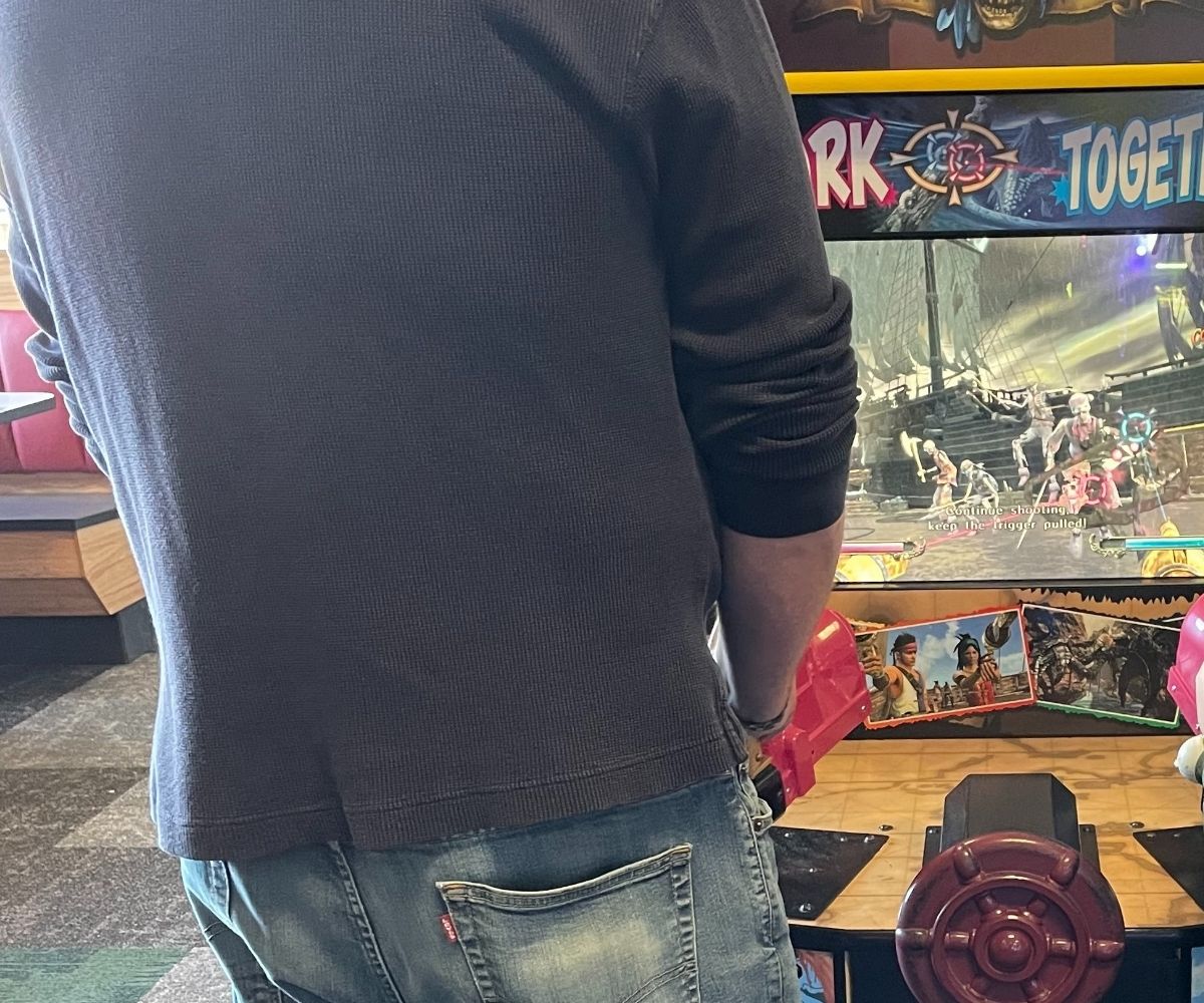 man playing an arcade game
