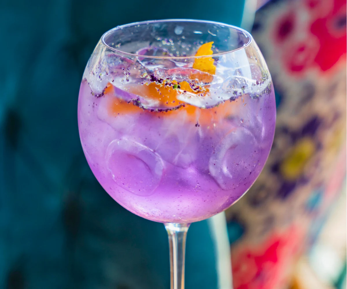 bluish purple mocktail drink in a wine glass