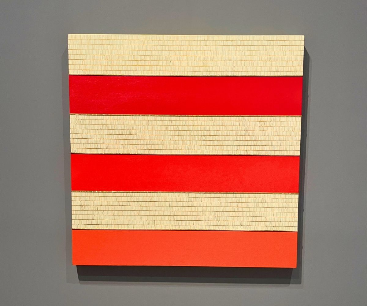 piece of modern art with red and white strips
