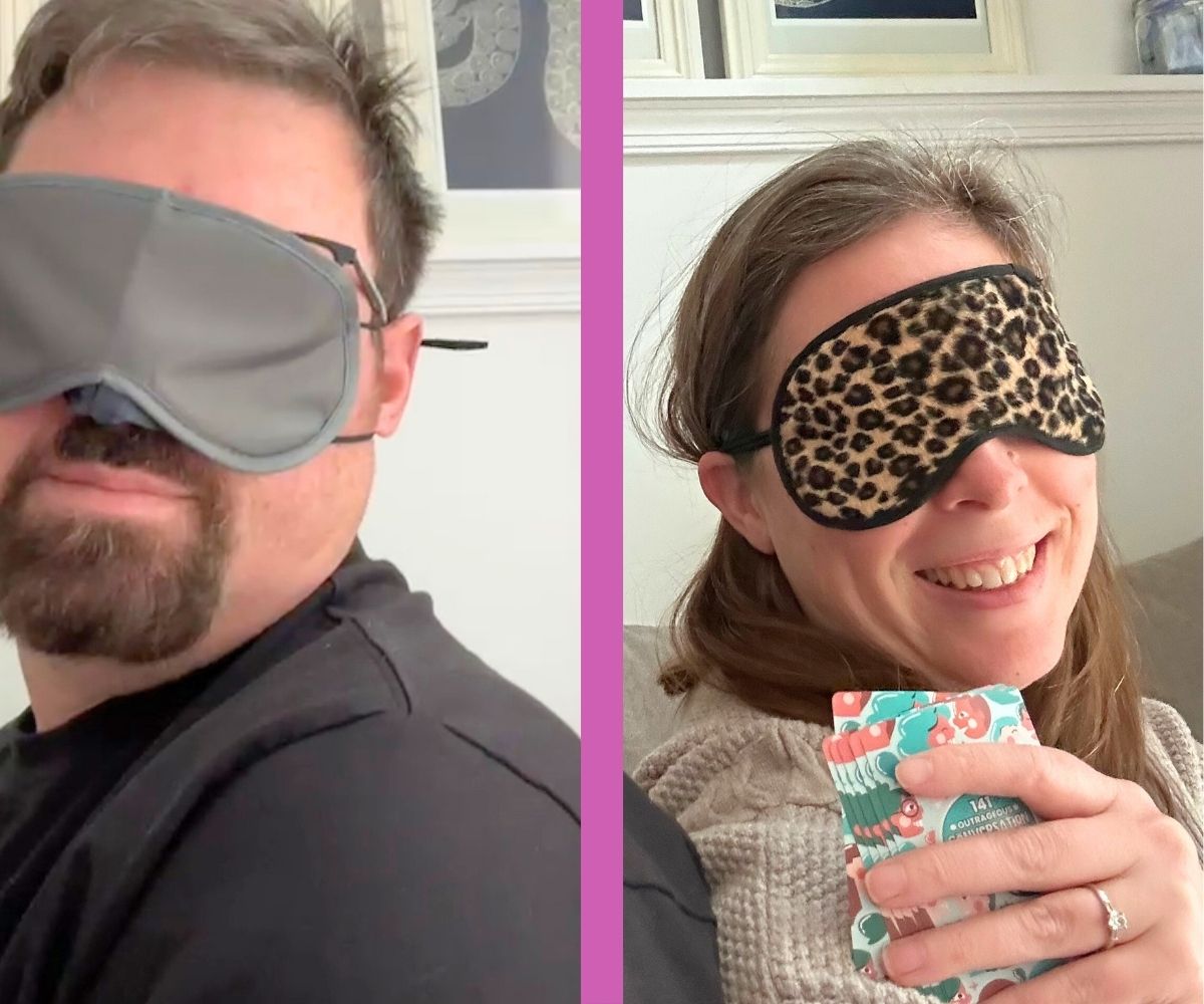 blogger and her husband with blindfolds on, sitting on couch