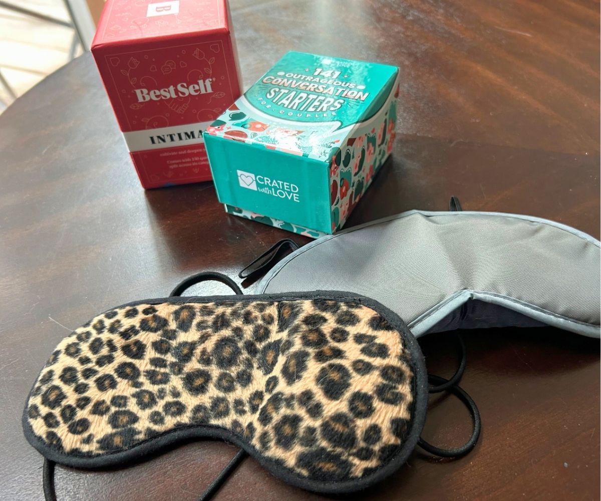 two blindfolds, and two decks of conversation starter cards for couples