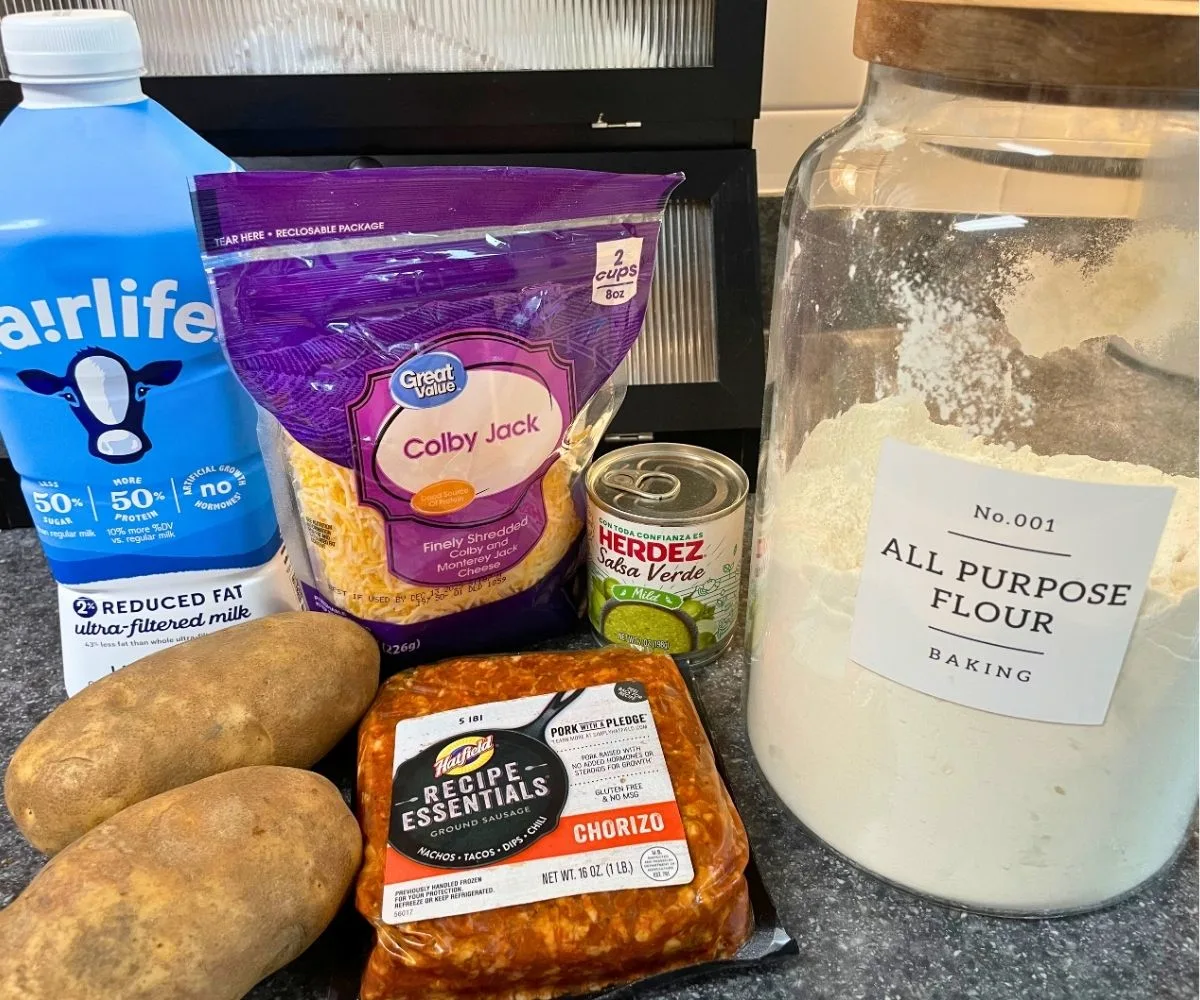collection of ingredients for stuffed baked potato recipe on kitchen counter