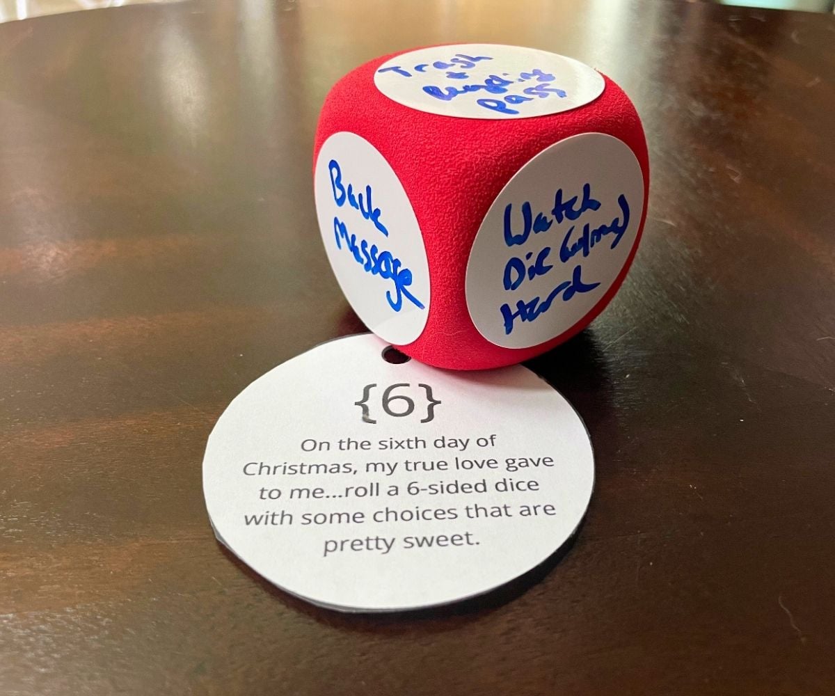 dry erase dice with handwritten rewards on each side, and ornament shaped tag