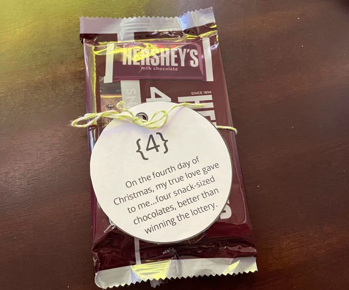 four pack of snack-sized hershey's bars with ornament shaped tag tied to it