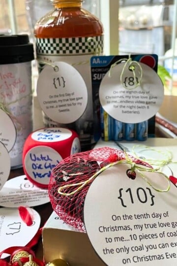 lots of items with ornament shaped tags tied to them for 12 days of Christmas gifts