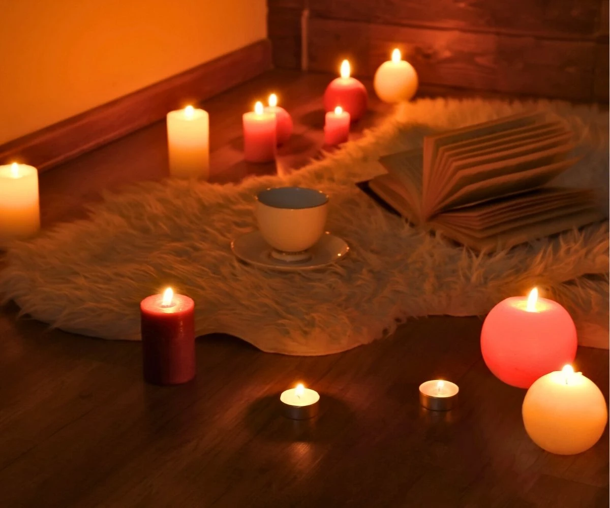 furry rug with candles lit all around, and a local ghost folklore book opened on it