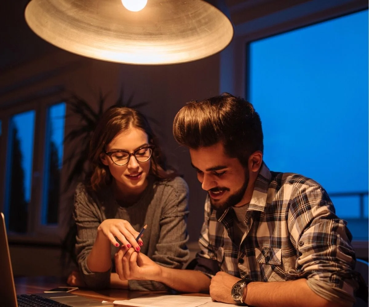 couple smiling at night, working on a printable escape room together