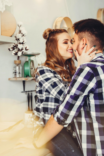 couple flirting in flannels in kitchen