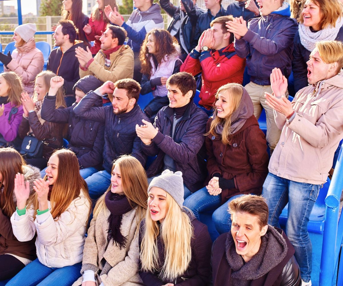 couples in stadium cheering on local football team