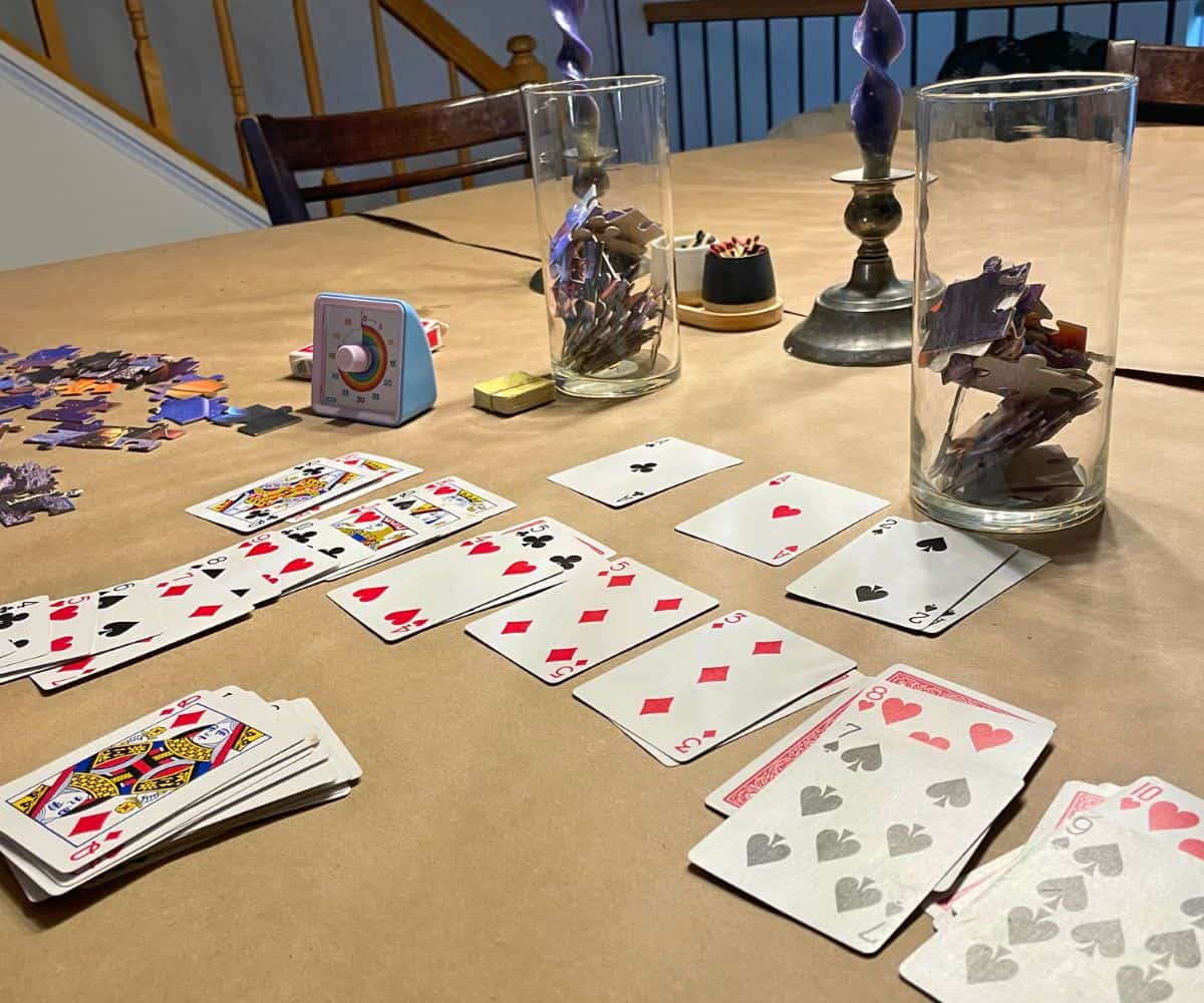 solitaire game in progress in front of one vase of puzzle pieces to unlock it