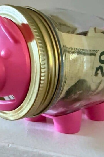 bright pink pig mason jar bank with $20s in it