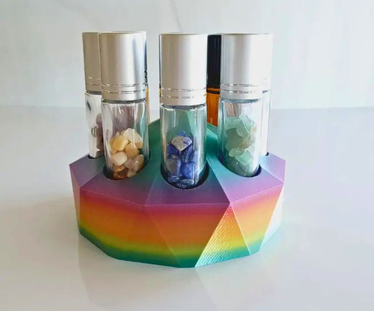 rainbow colored 3-D printed essential oil holder on white surface