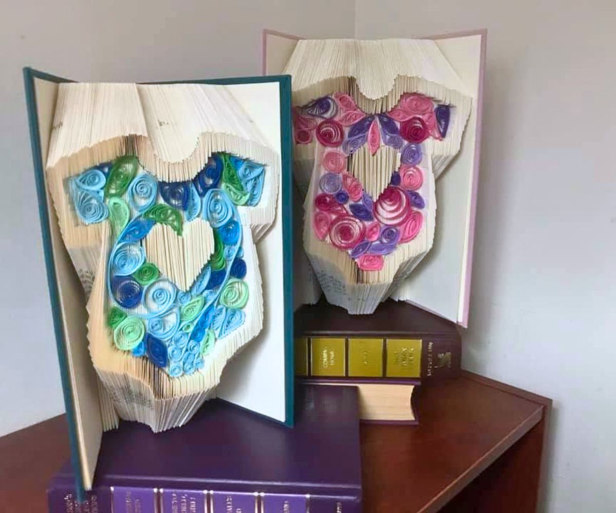 two very colorful books folded into a boy and girl onesie