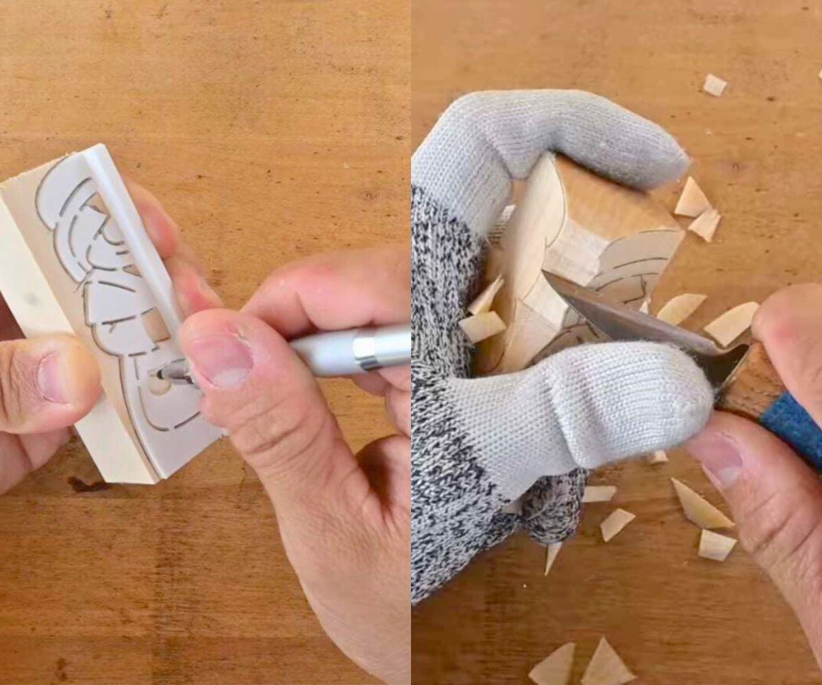 man using handmade stencils to carve a piece of wood into Mr. and Mrs. Claus